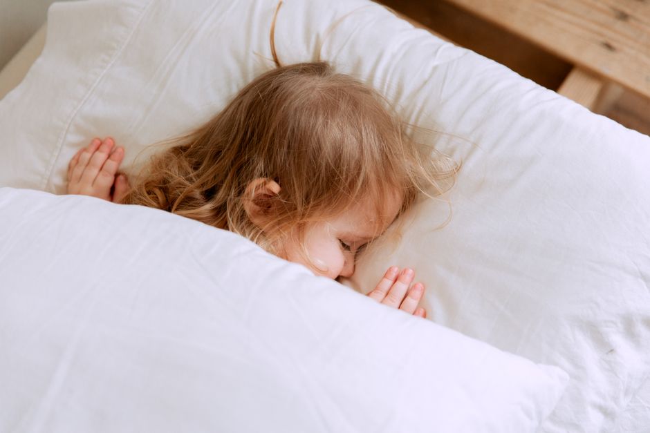 布団で眠る小さな子ども